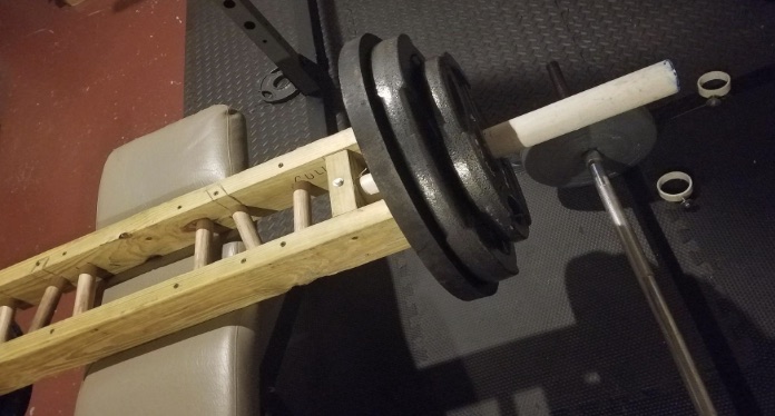 Wooden multi-grip Swiss bar loaded with weight plates